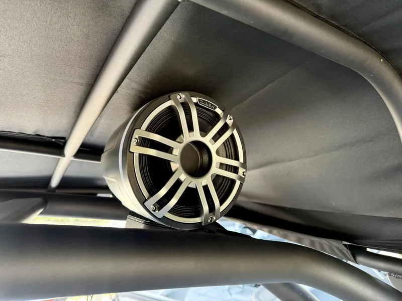 Slide: The Image of Speaker mounted on Yamaha Boats 255XD, 2025 model, under a canopy. - 14