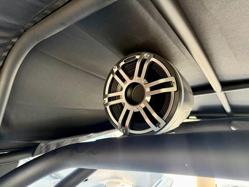 Slide: The Image of Speaker mounted on Yamaha Boats 255XD, 2025 model, under a canopy. - 15