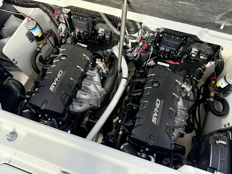 Slide: The Image of 2025 Yamaha Boats 255XD engine compartment with twin SVHO engines and wiring. - 16