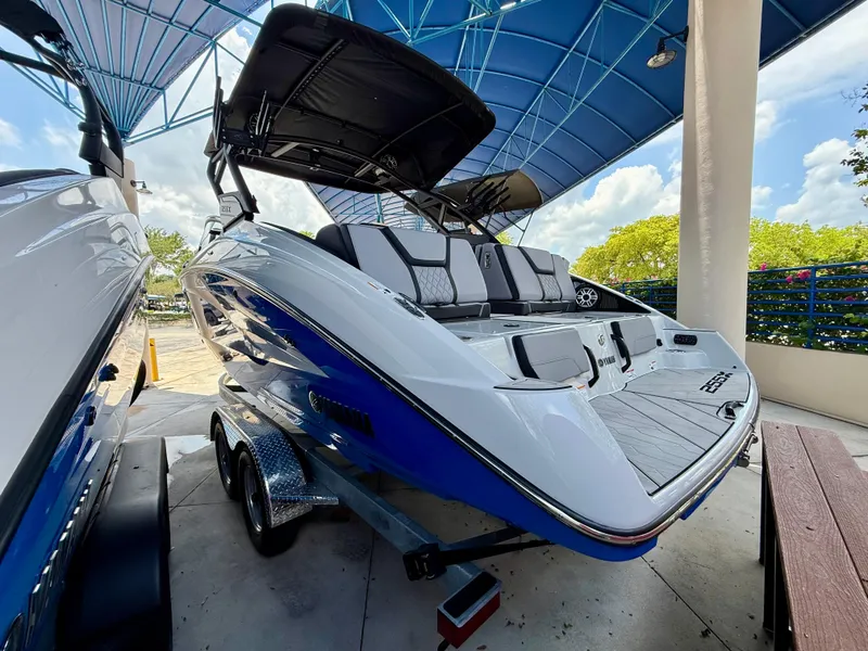 Slide: The Image of 2025 Yamaha Boats 255XD with sleek design under a blue canopy. - 3