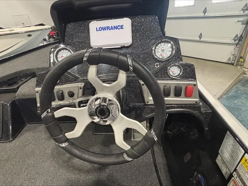 Slide: The Image of Steering wheel and dashboard of a 2025 Nitro Z18 boat with Lowrance display. - 12