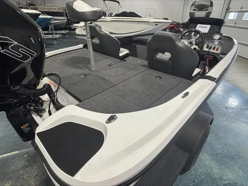 Slide: The Image of 2025 Nitro Z18 boat interior with seating, control panel, and motor in a showroom. - 3