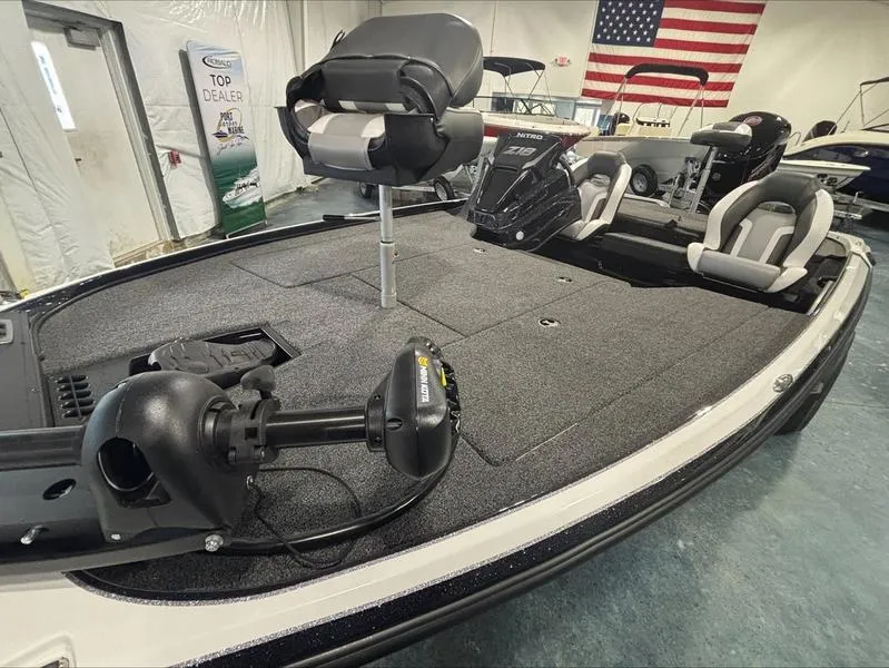 Slide: The Image of 2025 Nitro Z18 boat interior with seating and equipment, displayed indoors with an American flag. - 5