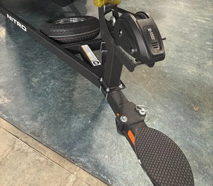 Slide: The Image of Trailer hitch of a 2025 Nitro Z18 boat on a textured floor. - 6