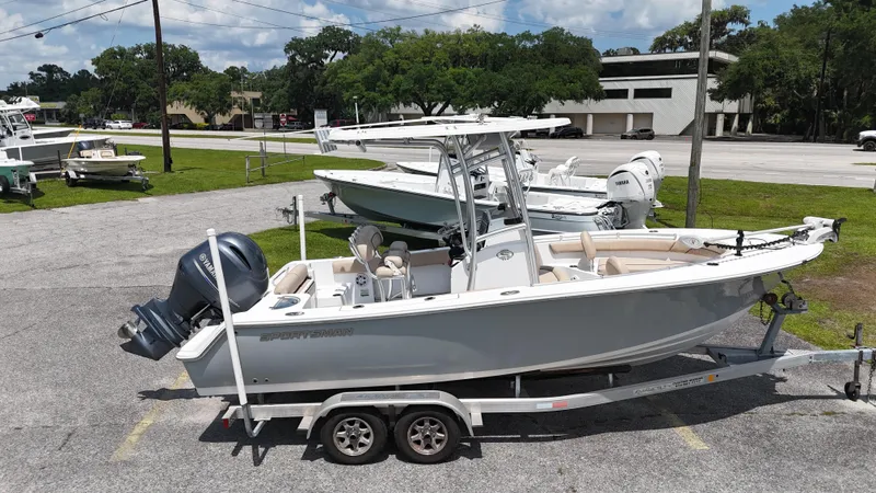 The Image of 2019 Sportsman Open 212 Center Console boat on trailer in parking lot. - 1