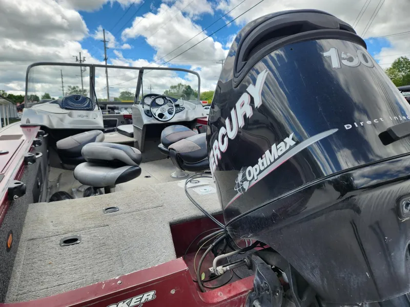 Slide: The Image of 2011 Tracker Targa V-18 Combo boat with Mercury OptiMax engine, under a cloudy sky. - 11