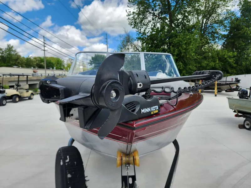 Slide: The Image of 2011 Tracker Targa V-18 Combo boat with Minn Kota trolling motor, parked outdoors. - 13
