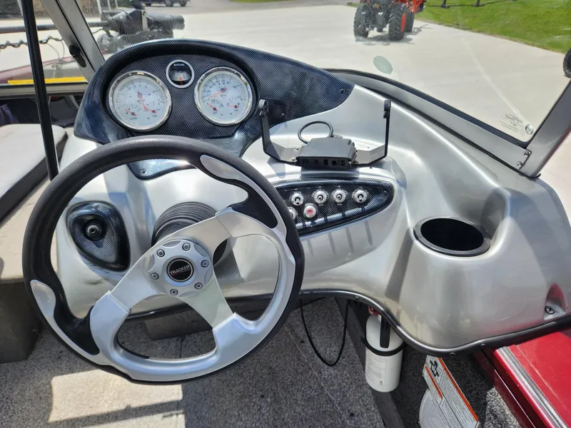 Slide: The Image of 2011 Tracker Targa V-18 Combo boat dashboard with steering wheel and gauges. - 7