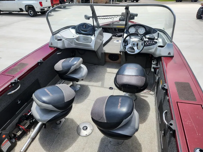 Slide: The Image of 2011 Tracker Targa V-18 Combo boat interior with four seats and steering console. - 9