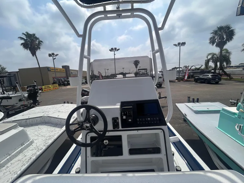 Slide: The Image of 2025 Shallow Stalker CAT211PRO boat console with steering wheel and controls, outdoor display setting. - 10