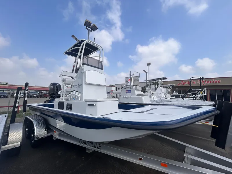 Slide: The Image of 2025 Shallow Stalker CAT211PRO boat on trailer at dealership under cloudy sky. - 2