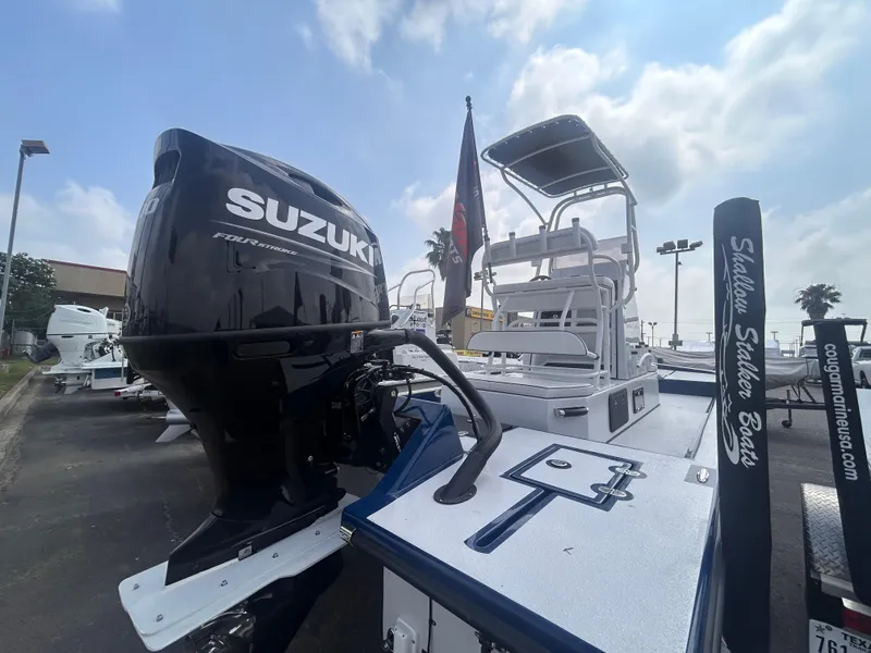 Slide: The Image of Shallow Stalker CAT211PRO 2025 boat with Suzuki engine, docked under a cloudy sky. - 4