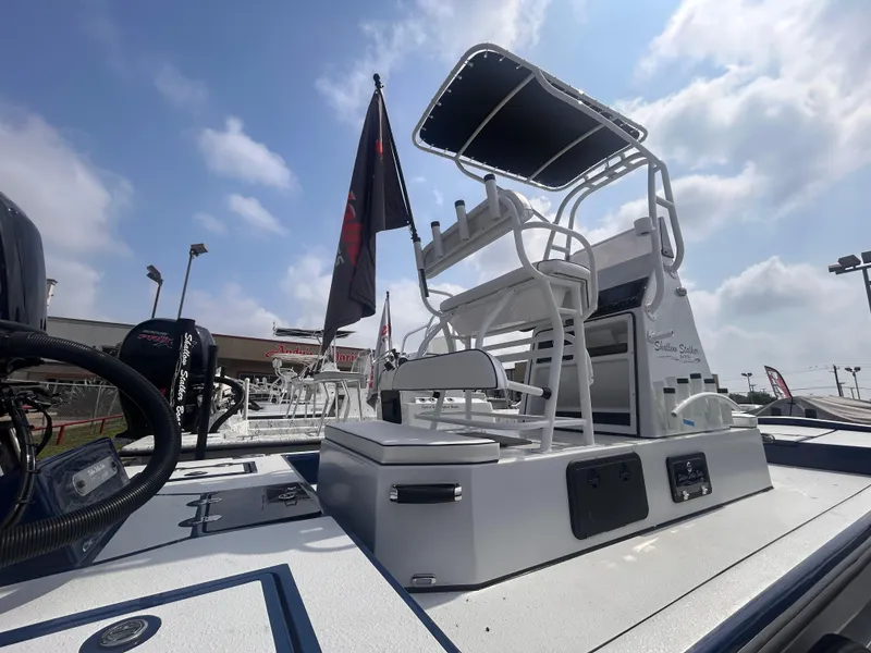 Slide: The Image of 2025 Shallow Stalker CAT211PRO boat with elevated seating and canopy under a cloudy sky. - 7