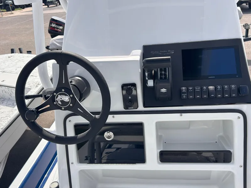 Slide: The Image of Steering console of 2025 Shallow Stalker CAT211PRO boat with modern controls and display. - 9