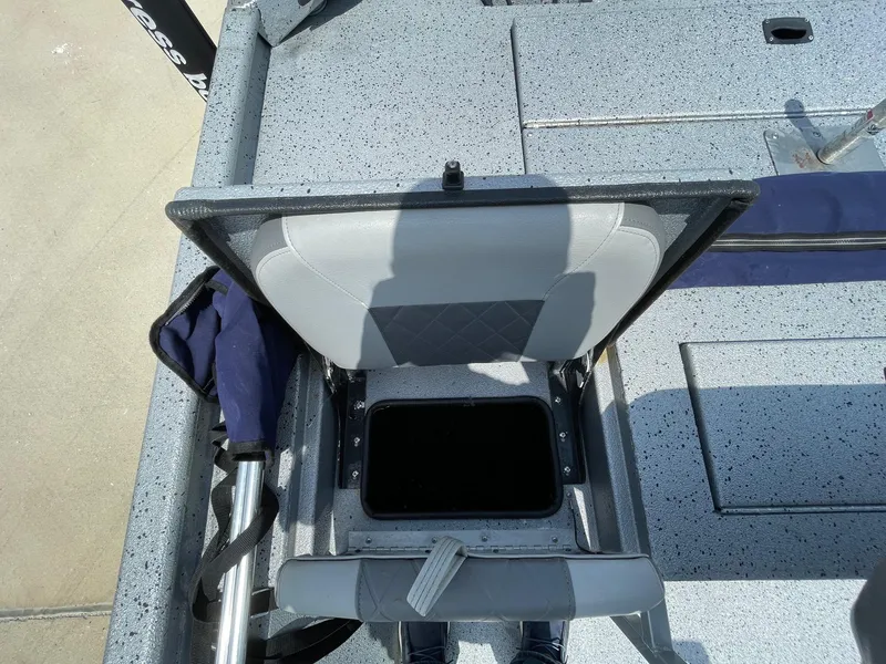 Slide: The Image of 2019 Xpress XP20CC boat seat with open storage compartment, showing interior details. - 12