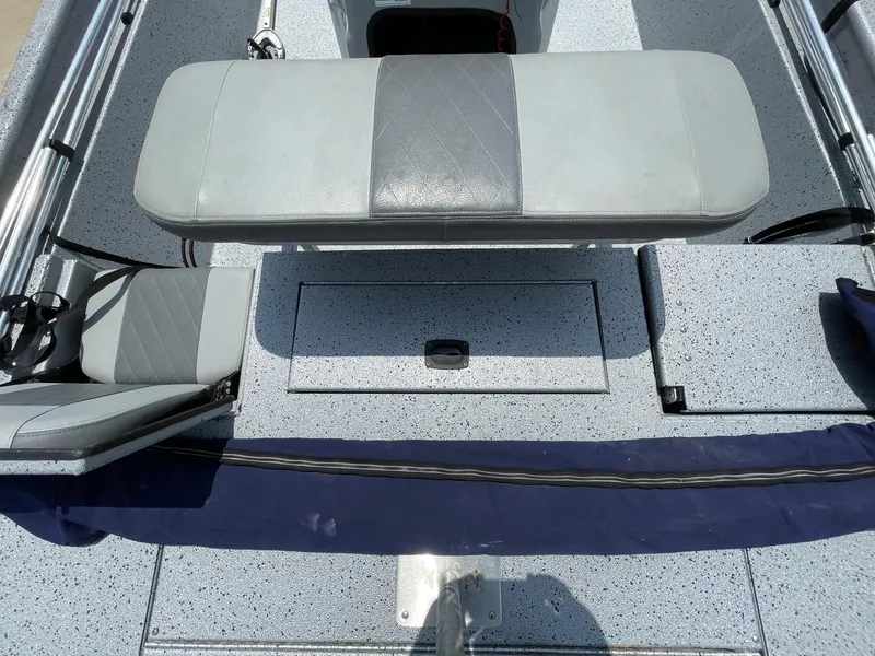 Slide: The Image of 2019 Xpress XP20CC boat interior with gray seating and storage compartments. - 14