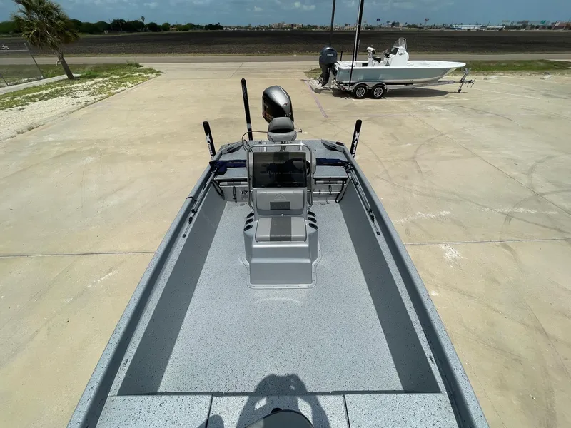 Slide: The Image of 2019 Xpress XP20CC boat on concrete, with another boat in the background. - 18