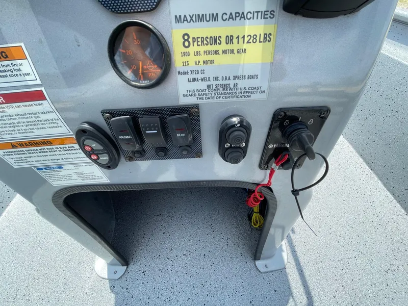 Slide: The Image of Control panel of 2019 Xpress XP20CC boat with capacity and warning labels. - 21