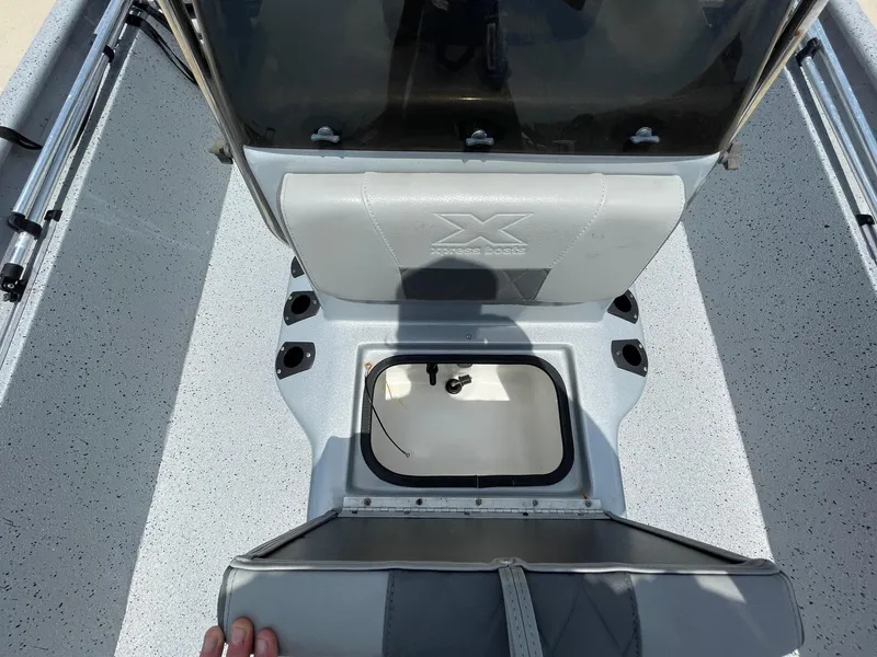 Slide: The Image of 2019 Xpress XP20CC boat interior with storage compartment and seating. - 23