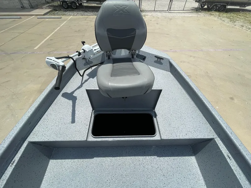 Slide: The Image of 2019 Xpress XP20CC boat with gray seat and storage compartment on deck. - 25