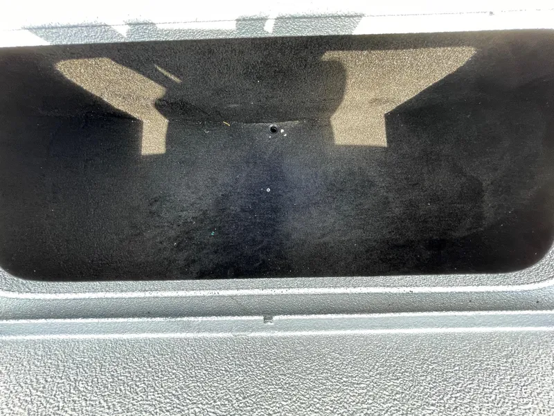 Slide: The Image of Empty storage compartment of 2019 Xpress XP20CC boat, interior view. - 26