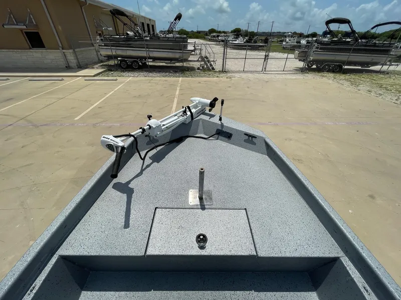 Slide: The Image of 2019 Xpress XP20CC boat deck with trolling motor in a parking lot. - 27