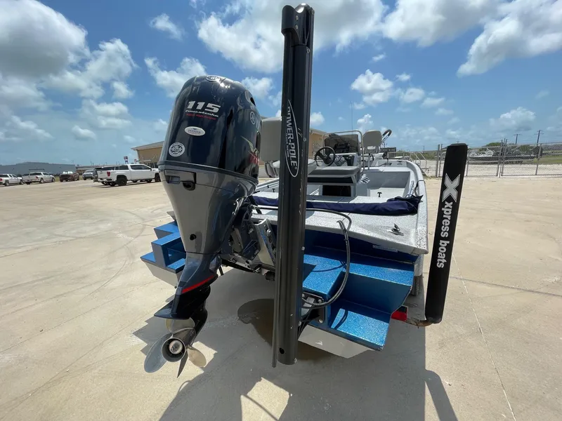 Slide: The Image of 2019 Xpress XP20CC boat with Yamaha 115 outboard motor, parked outdoors. - 8