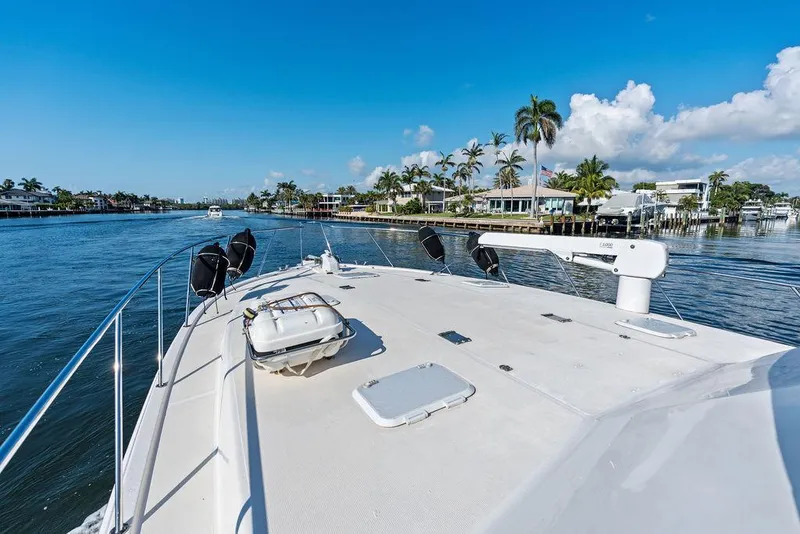 Slide: The Image of Bow of 2001 Riviera 48 yacht with anchor and railing on calm water. - 18