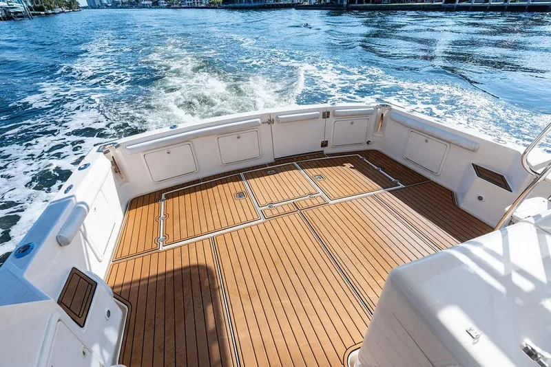 Slide: The Image of Spacious deck of 2001 Riviera 48 yacht with wooden flooring and scenic water view. - 22