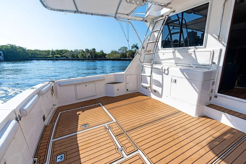 Slide: The Image of Riviera 48 yacht deck, 2001 model, cruising on a sunny day with waterfront views. - 23