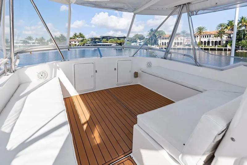 Slide: The Image of Spacious seating area on 2001 Riviera 48 yacht with teak flooring and marina view. - 27