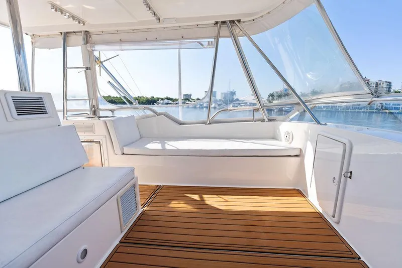 Slide: The Image of Cockpit of 2001 Riviera 48 yacht with modern navigation equipment and wooden flooring. - 29