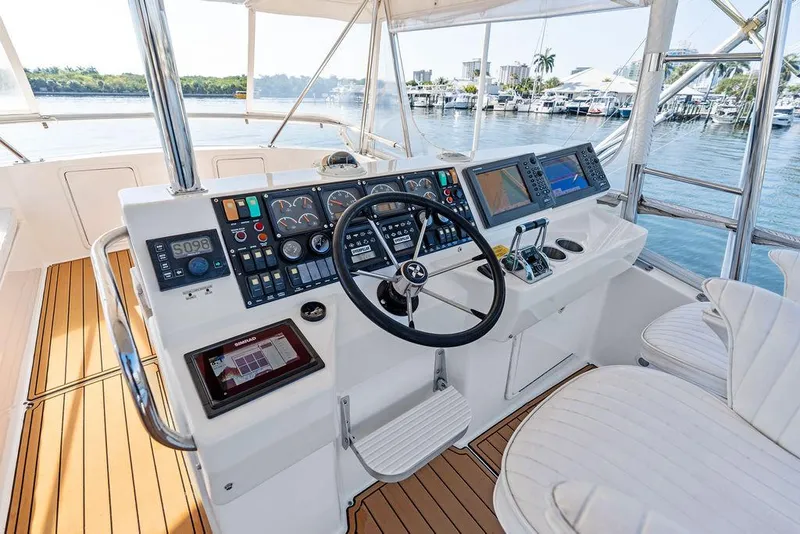 Slide: The Image of Cockpit of 2001 Riviera 48 yacht with navigation instruments and steering wheel. - 30