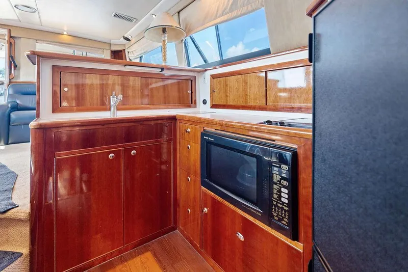 Slide: The Image of Luxurious 2001 Riviera 48 yacht interior with elegant wood finish and comfortable seating. - 44