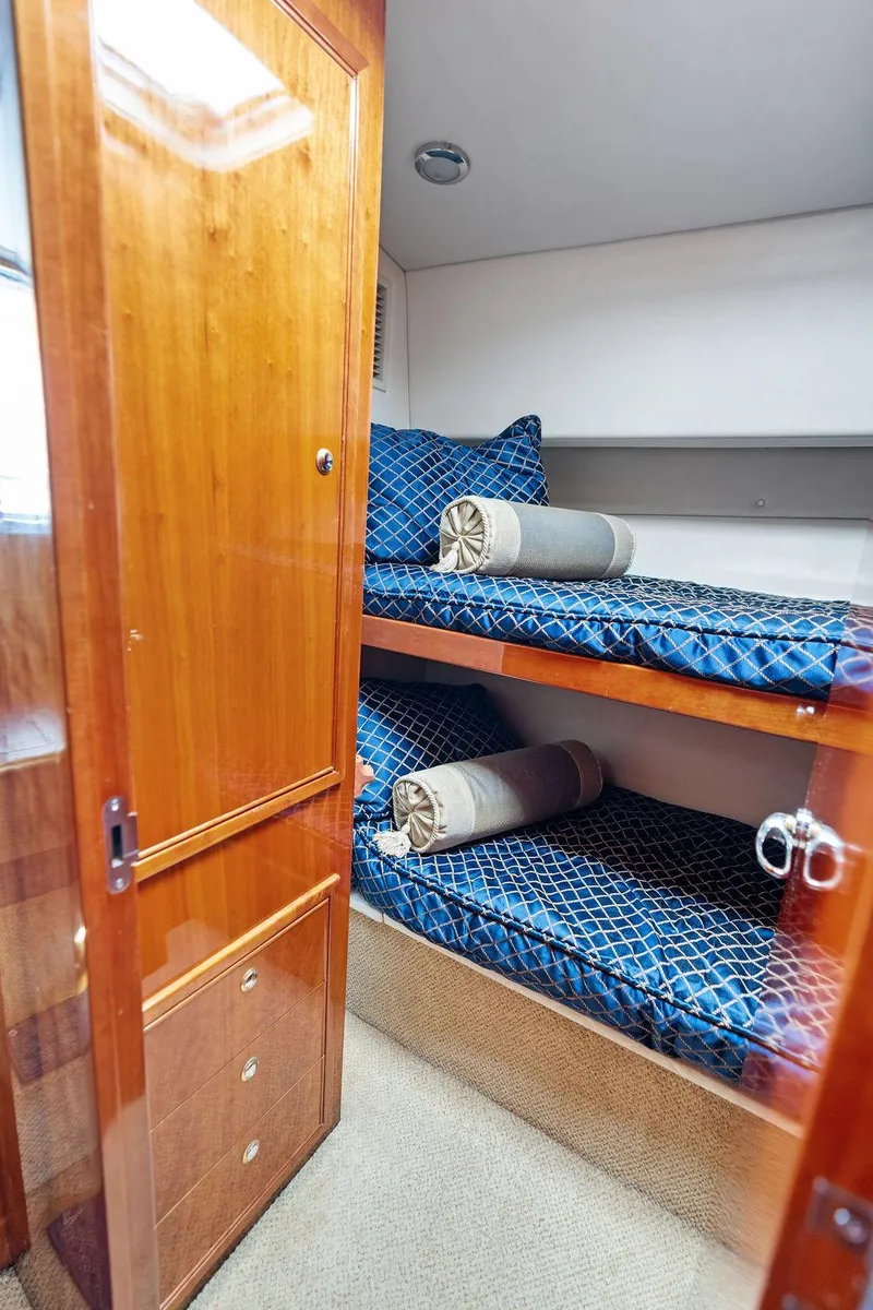 Slide: The Image of Luxurious cabin interior of a 2001 Riviera 48 yacht with elegant bedding. - 47