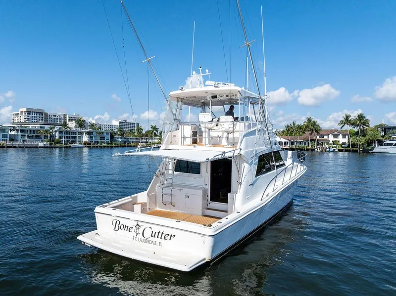 Slide: The Image of Aerial view of 2001 Riviera 48 yacht on calm green water. - 11