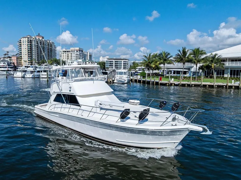 Slide: The Image of Bow view of 2001 Riviera 48 yacht cruising on a sunny day. - 17