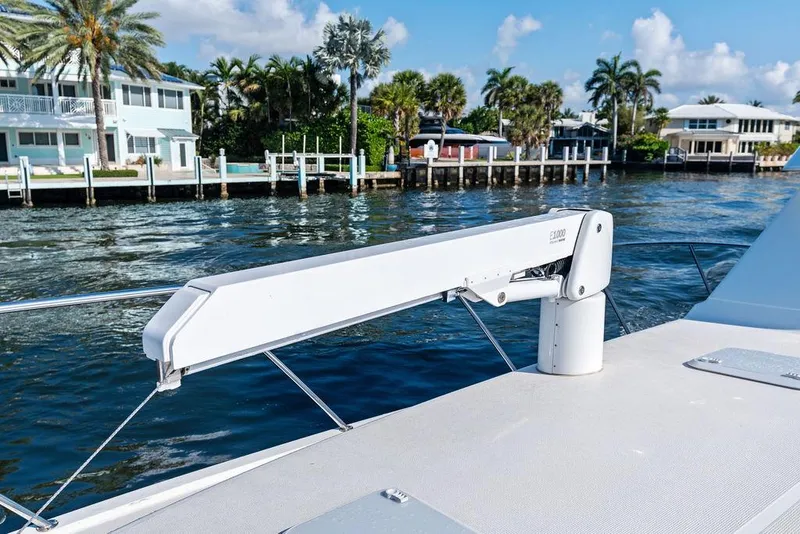 Slide: The Image of 2001 Riviera 48 boat deck with teak flooring, cruising on open water. - 21