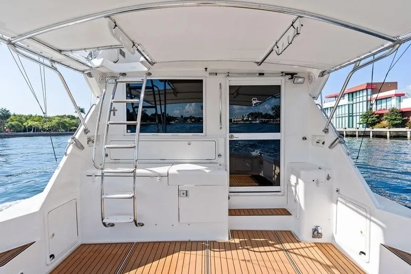 Slide: The Image of Riviera 48 yacht deck with scenic waterfront view, 2001 model. - 25