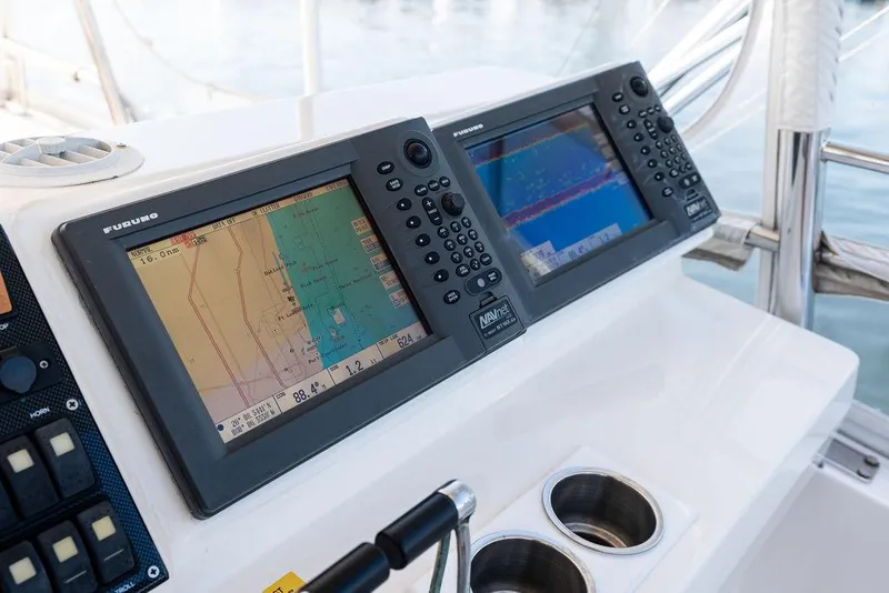 Slide: The Image of Control panel of a 2001 Riviera 48 yacht with communication equipment and scenic water view. - 35