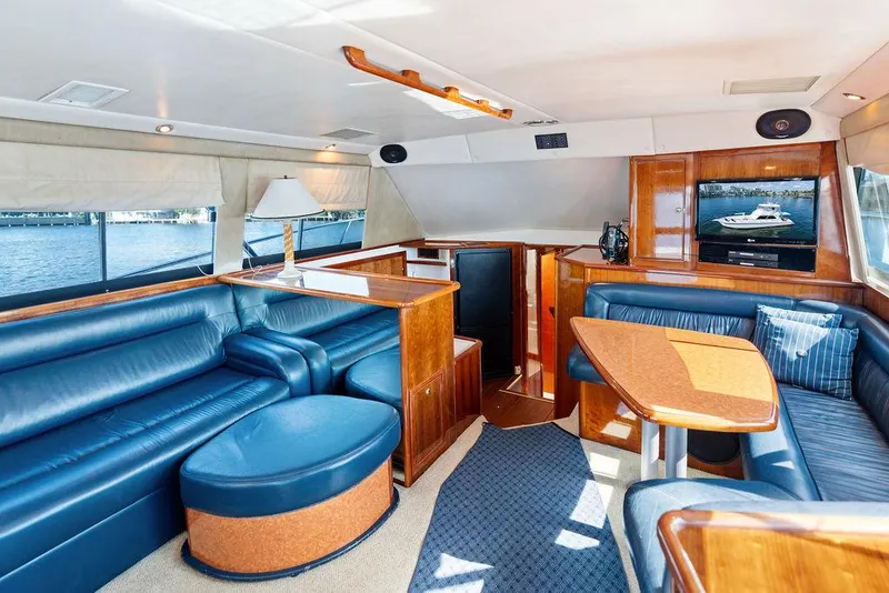 Slide: The Image of Luxurious interior of 2001 Riviera 48 yacht with blue leather seating and scenic windows. - 41