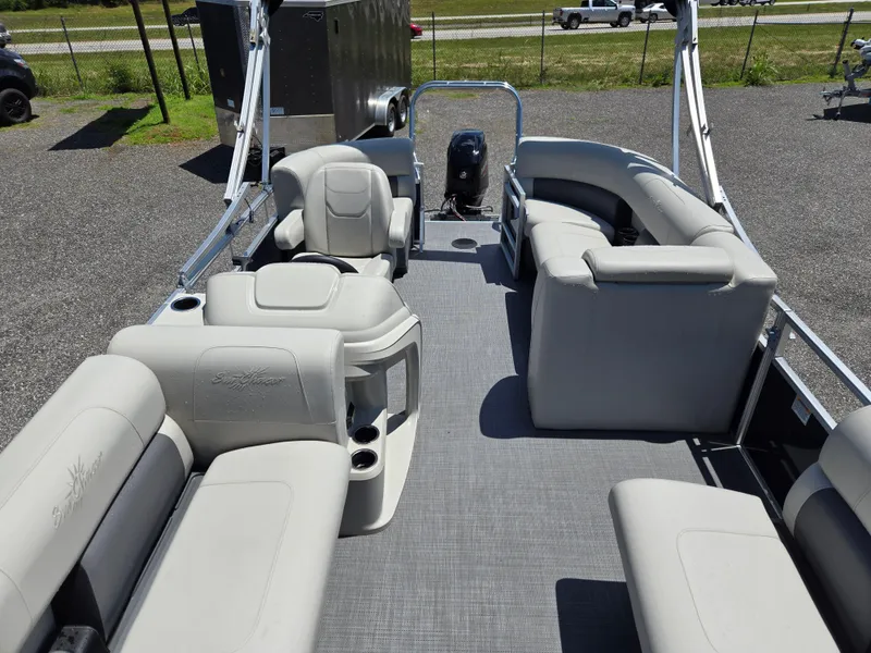 Slide: The Image of 2023 SunChaser Vista 18 LR pontoon boat interior with gray seating and open deck layout. - 14