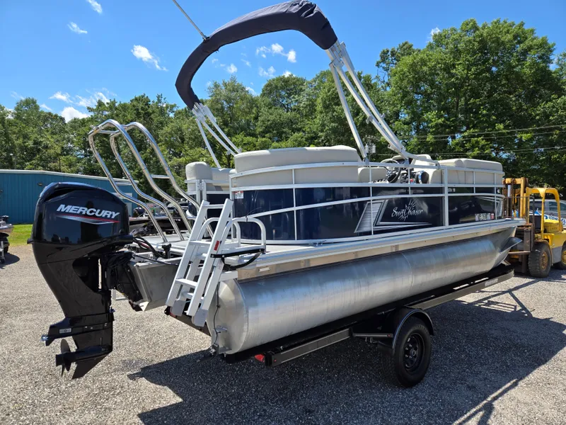 Slide: The Image of 2023 SunChaser Vista 18 LR pontoon boat on trailer with Mercury outboard motor. - 4