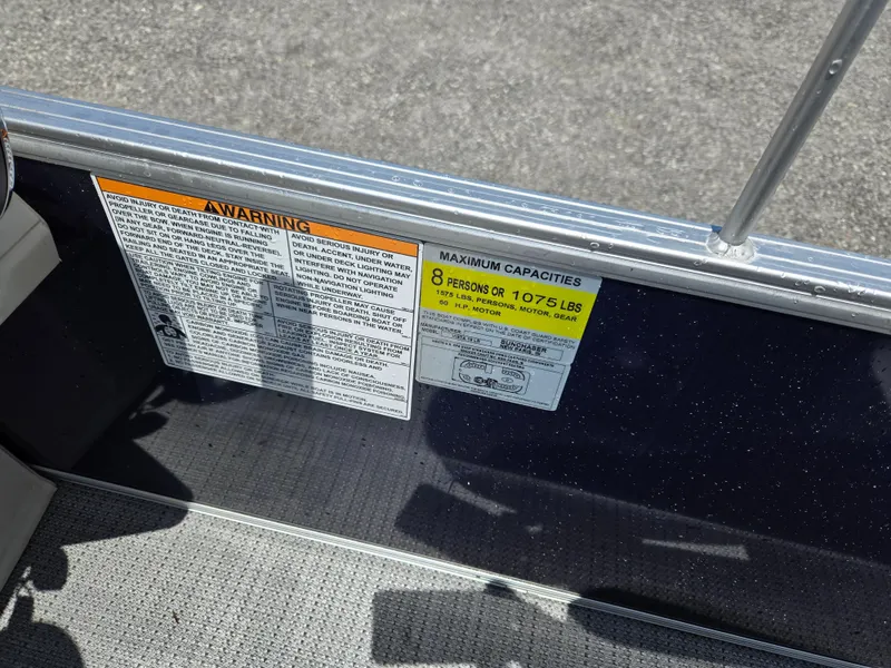 Slide: The Image of 2023 SunChaser Vista 18 LR capacity warning labels, indicating a maximum of 8 persons or 1075 lbs. - 7