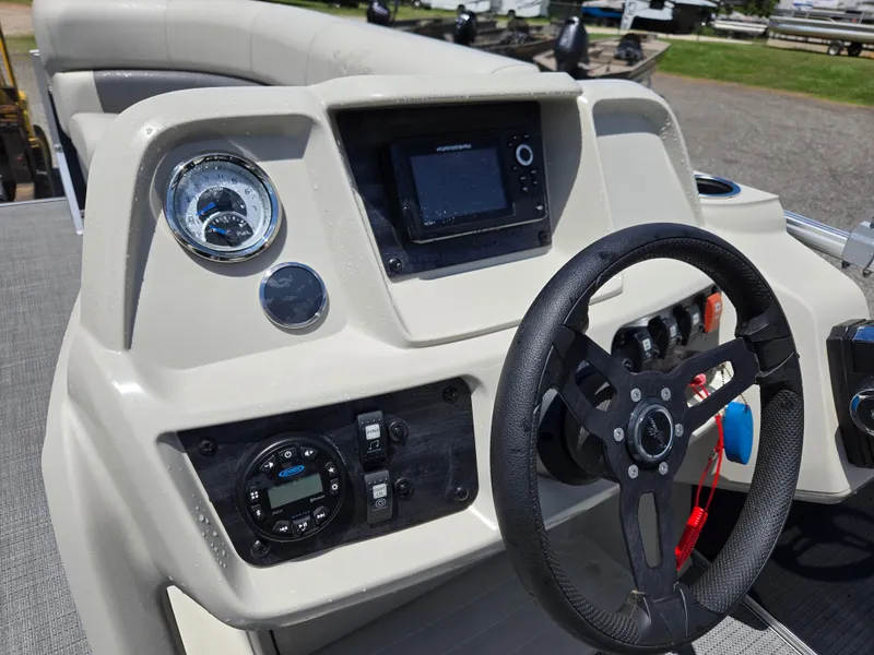 Slide: The Image of 2023 SunChaser Vista 18 LR boat dashboard with steering wheel and control panel. - 8