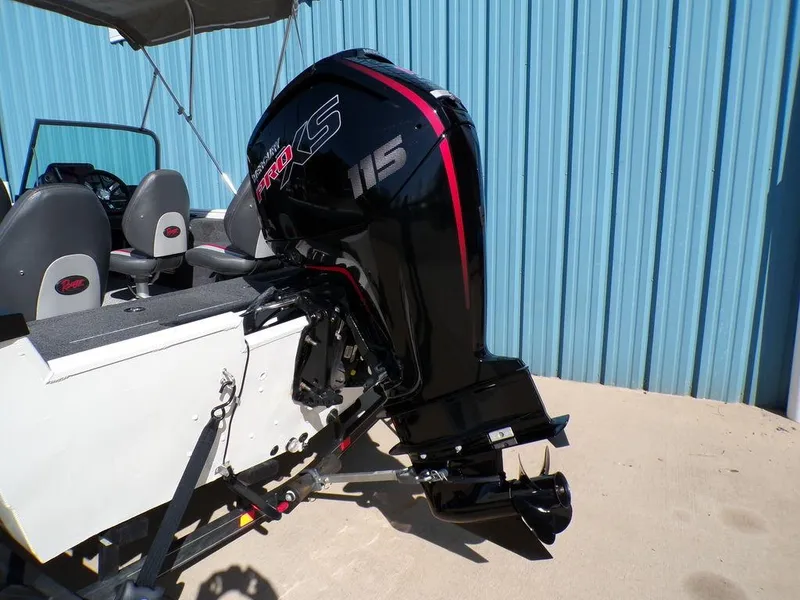 Slide: The Image of 2017 Ranger VS1780 boat with powerful outboard motor, parked near blue wall. - 12