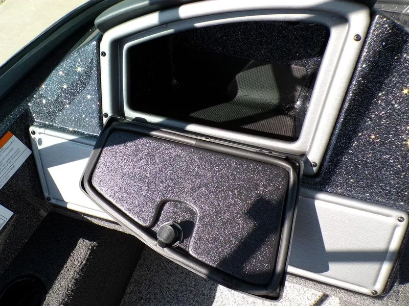 Slide: The Image of 2017 Ranger VS1780 boat storage compartment with open lid, showing interior details. - 2