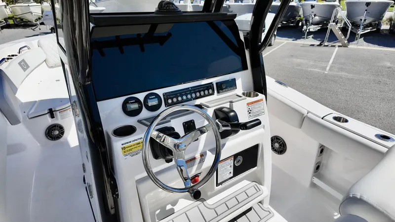 Slide: The Image of 2025 Sea Fox 248 Commander boat dashboard with steering wheel and controls. - 12