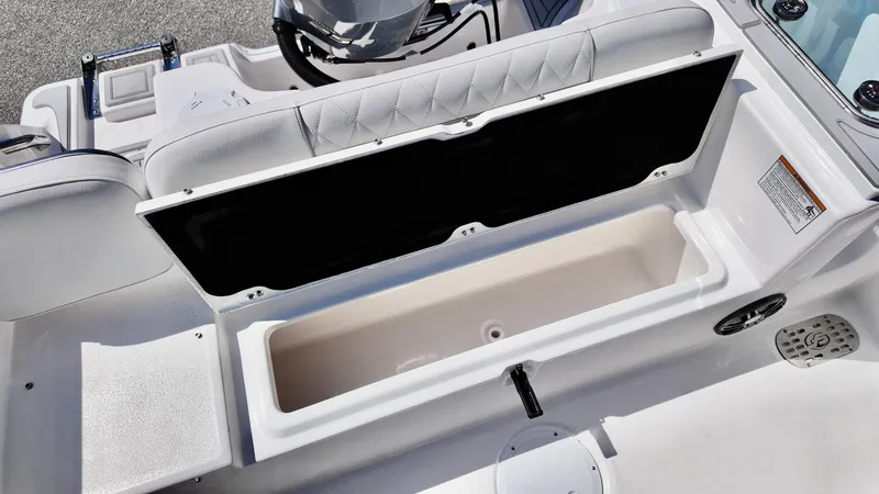 Slide: The Image of 2025 Sea Fox 248 Commander boat storage compartment, open with cushioned seating. - 14