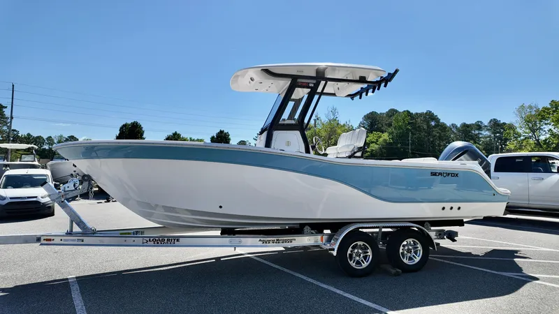 Slide: The Image of 2025 Sea Fox 248 Commander boat on trailer in parking lot. - 2
